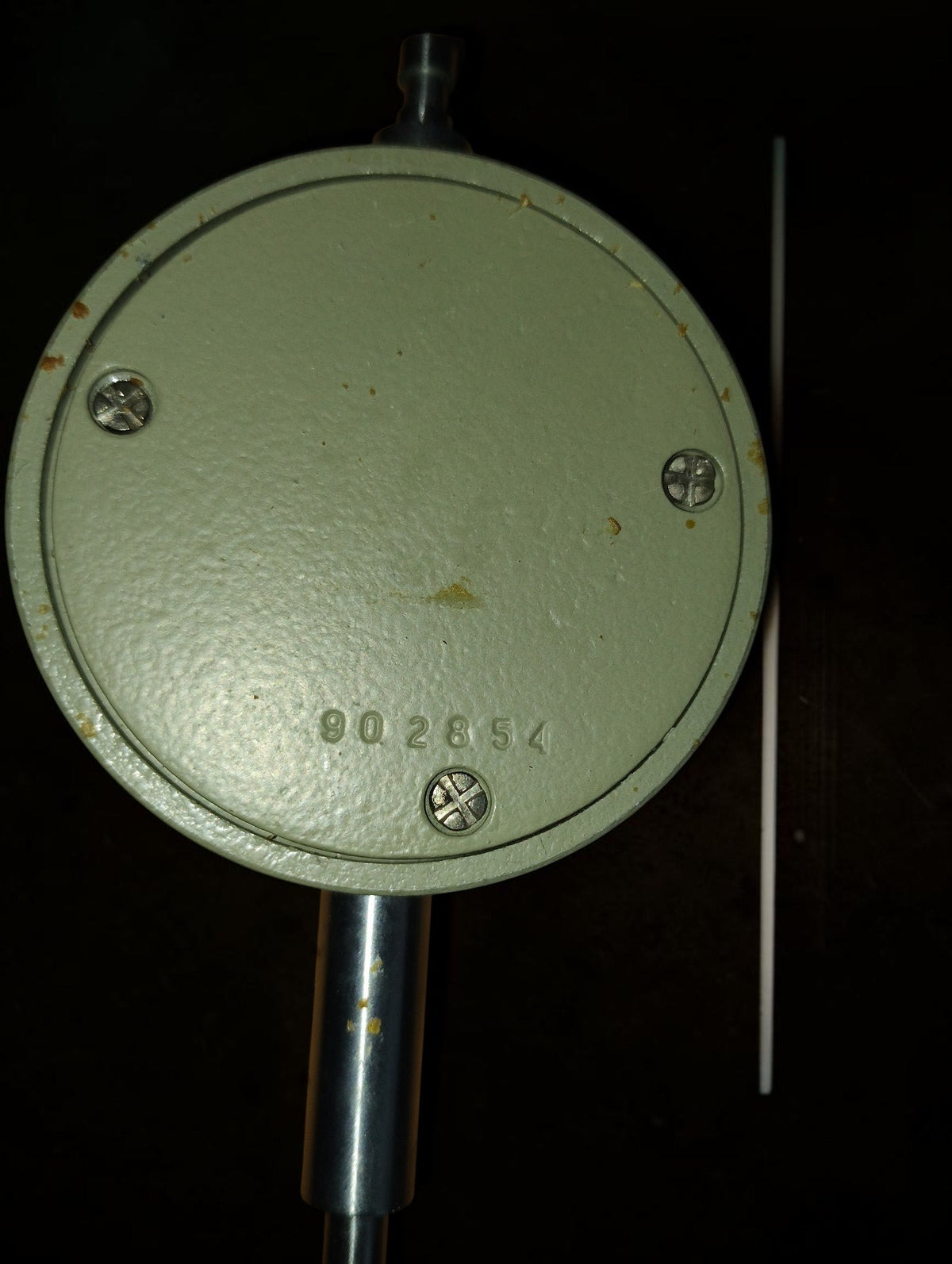 Rear of the Soviet dial indicator showing the metal housing and stamped number


