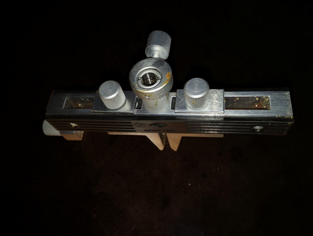 Top view of the Soviet gear tooth measuring frame showing adjustment knobs and dial indicator mounting socket

