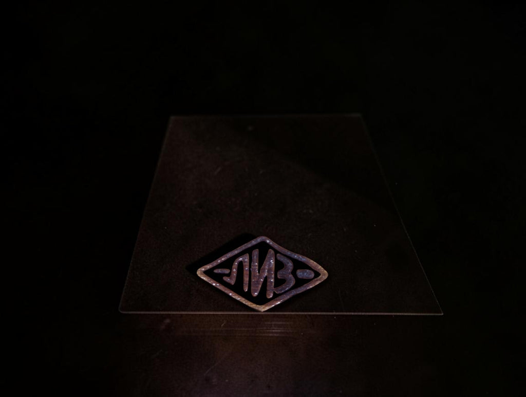 Close-up of the diamond-shaped LIZ factory logo

