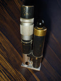 Vintage industrial inspection microscope with silver-coloured adjustment rings and a built-in lighting housing.
