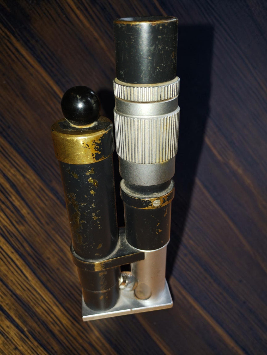Side view of the vintage inspection microscope showing the black body, lighting housing and rectangular base.
