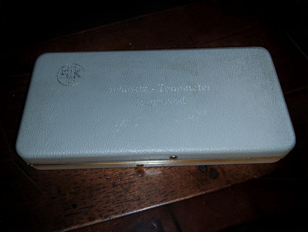 Closed pale blue case with embossed Schiötz Tonometer Improved lettering and SK logo.
