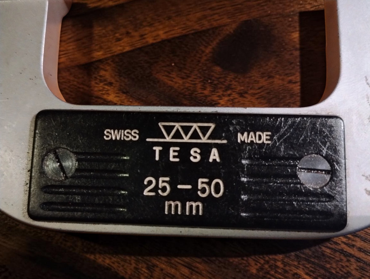 Close-up of the TESA logo, Swiss Made marking and 25–50 mm measuring range
