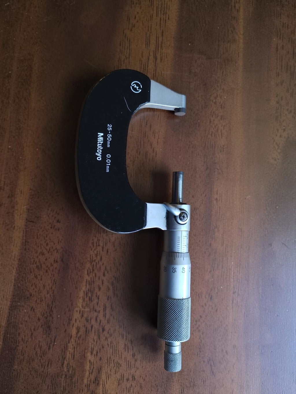 Mitutoyo No. 102-218 outside micrometer with a 25–50 mm measuring range, shown in full.

