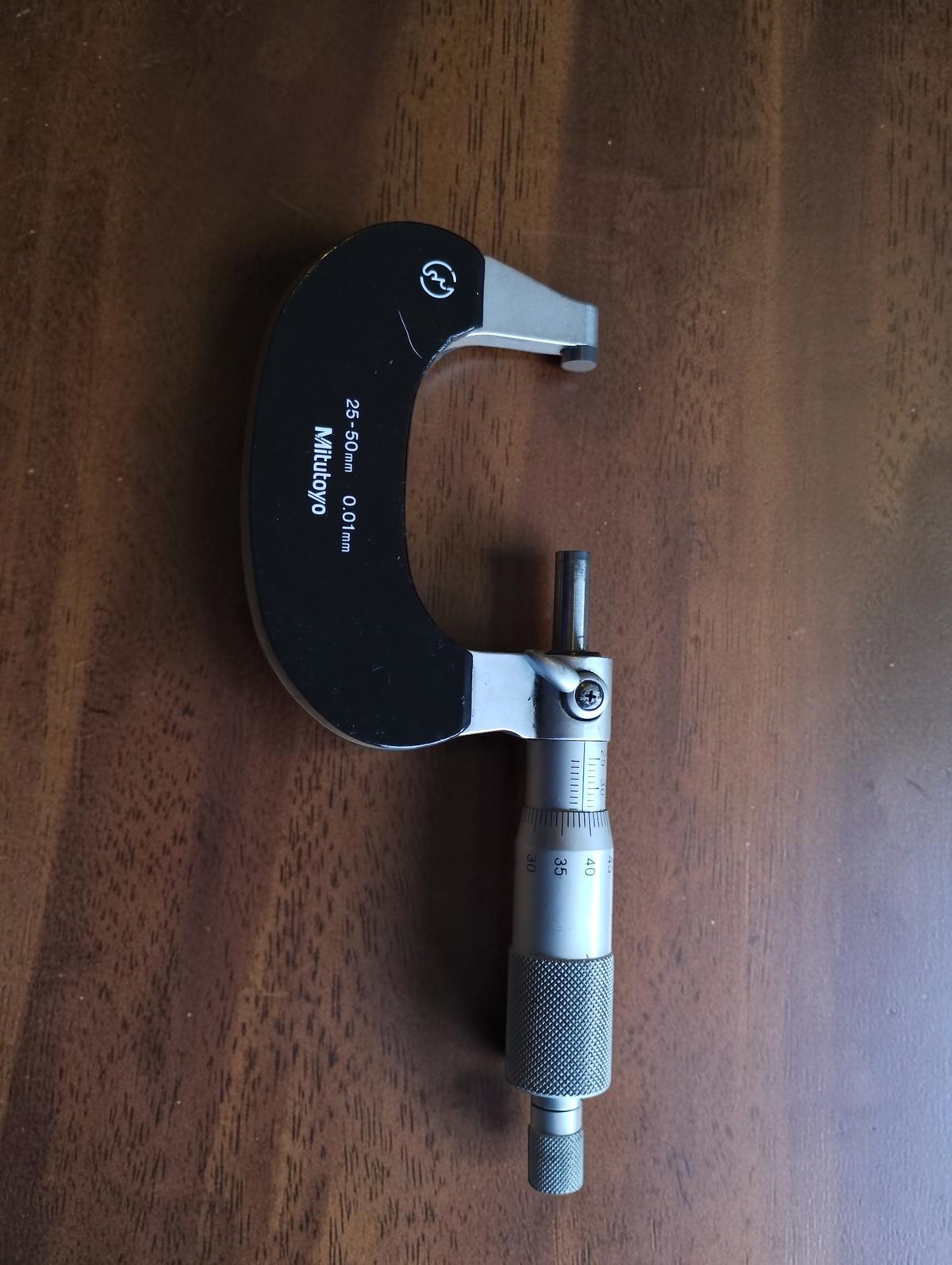 Mitutoyo No. 102-218 outside micrometer with a 25–50 mm measuring range, shown in full.


