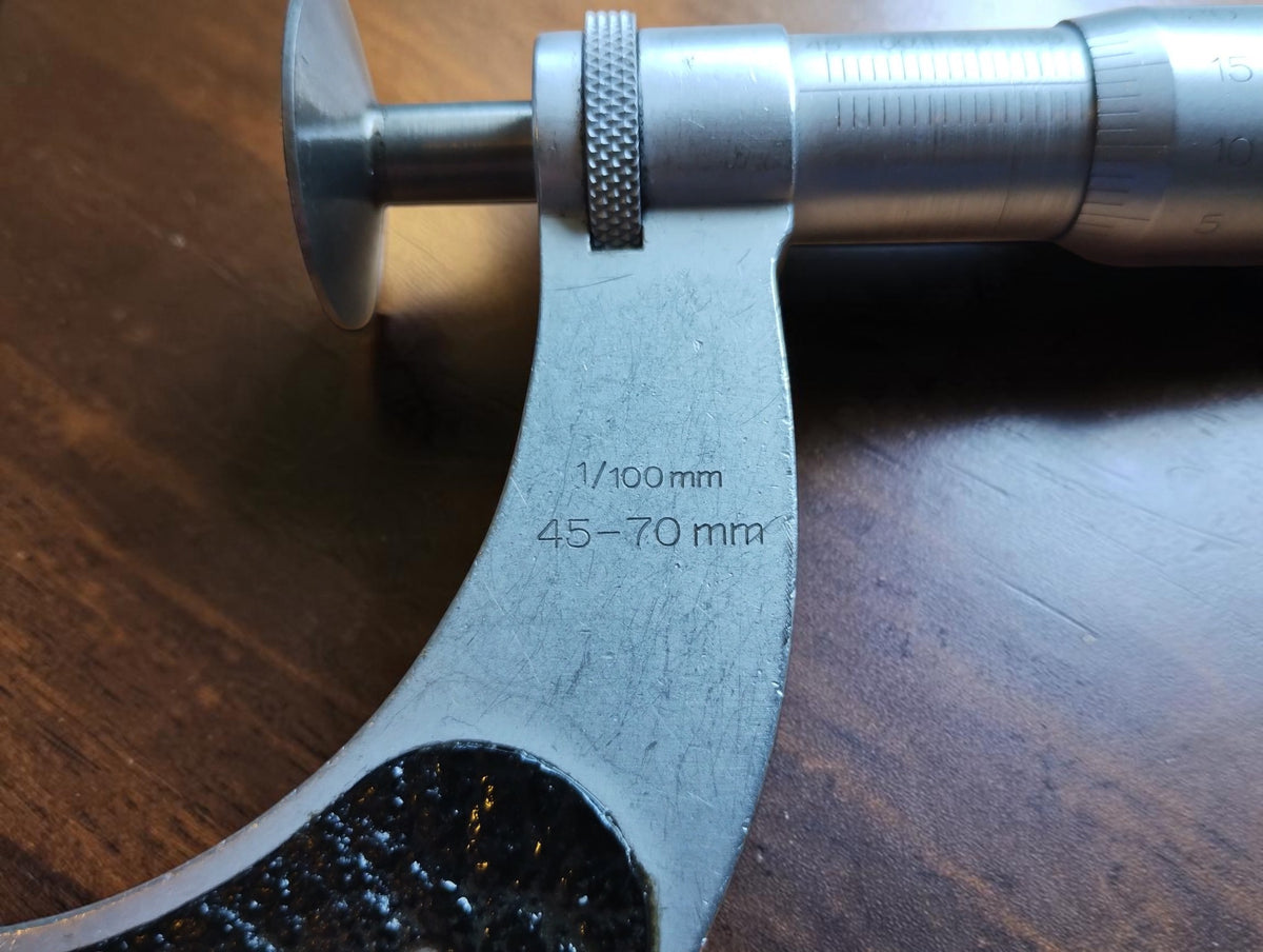 Mahr micrometer frame marked 45–70 mm and 1/100 mm, showing scratches from use.
