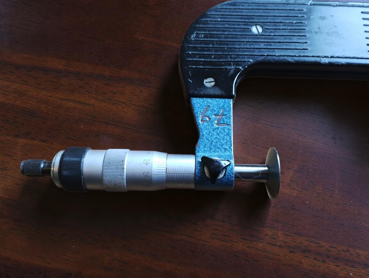 Detail van de Lufft meetspindel, stelknop en handgeschreven markering op het blauwe frame
