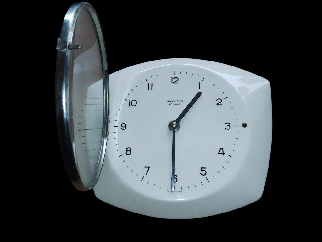 Junghans ATO-MAT wall clock with its hinged glass cover open.
