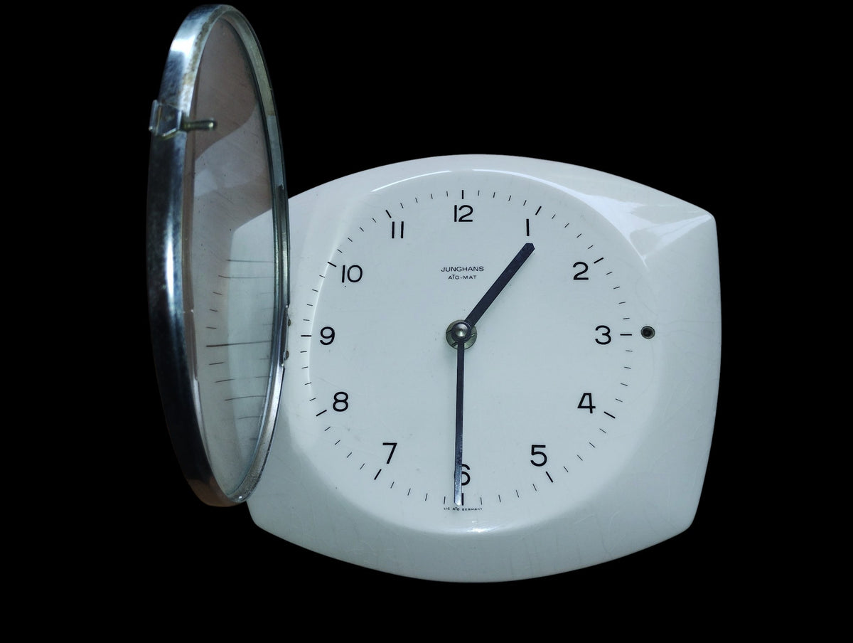 Junghans ATO-MAT wall clock with its hinged glass cover open.
