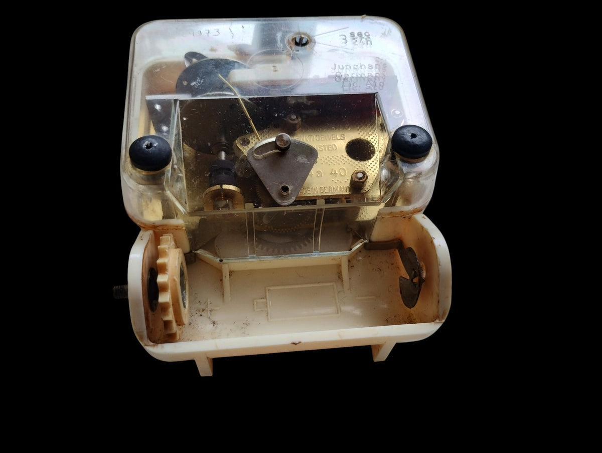 Back of the white ceramic Junghans wall clock, showing the movement, hanging bracket and markings.
