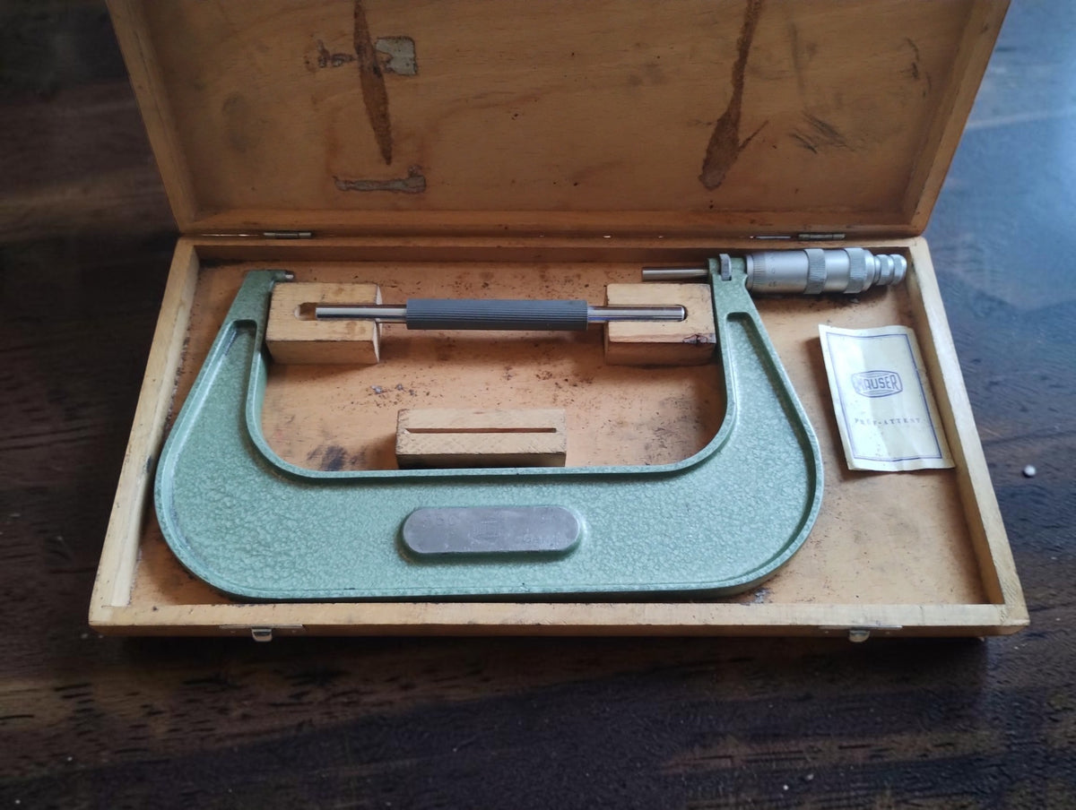 Mauser outside micrometer in an open wooden case with setting standard and Prüfattest booklet.
