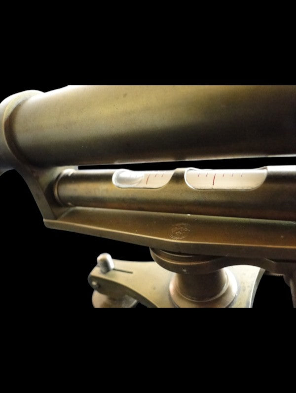 Full length view of antique brass surveyor's level with adjustment base